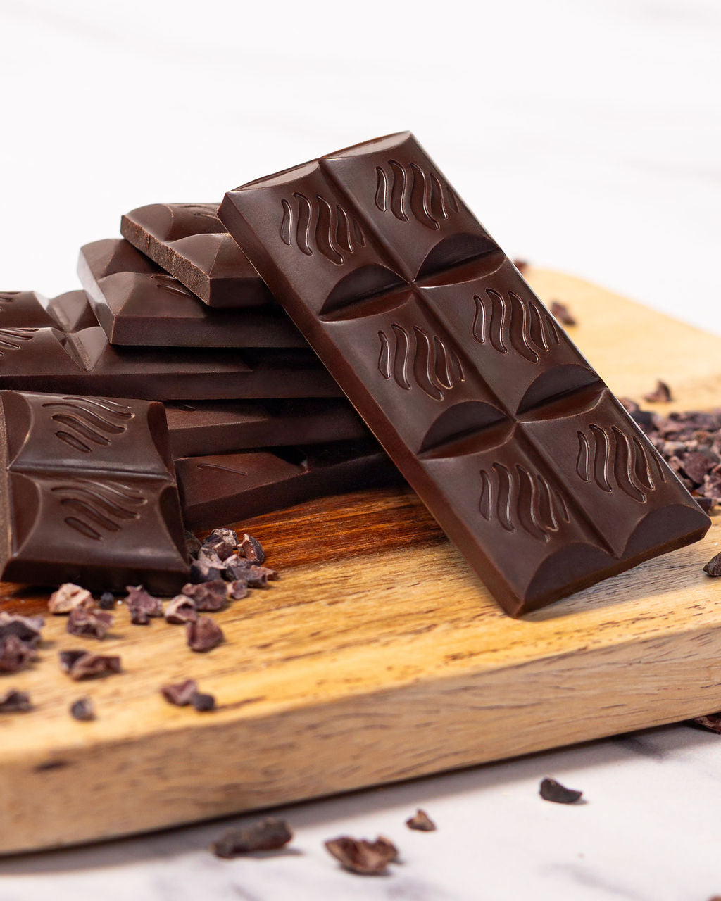 No Guilt Bars chocolate pieces on a board with almonds